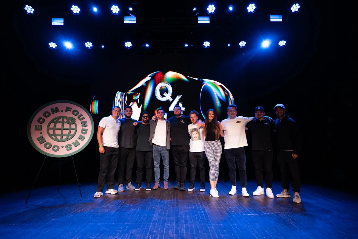 A group posing onstage at the Ecom Founders Q4 Summit